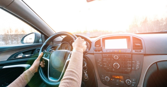teen driver's hand on wheels